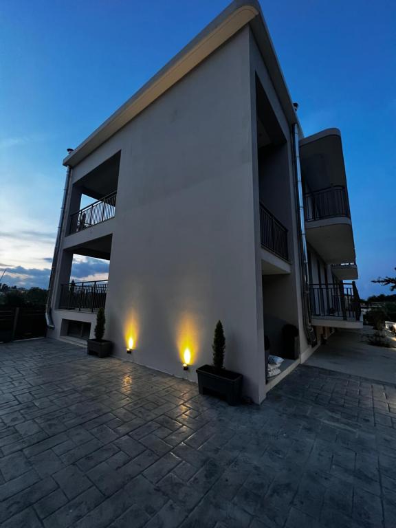 a large white building with lights on the side of it at Giannel Luxury Apartment 1 in Kastanéa