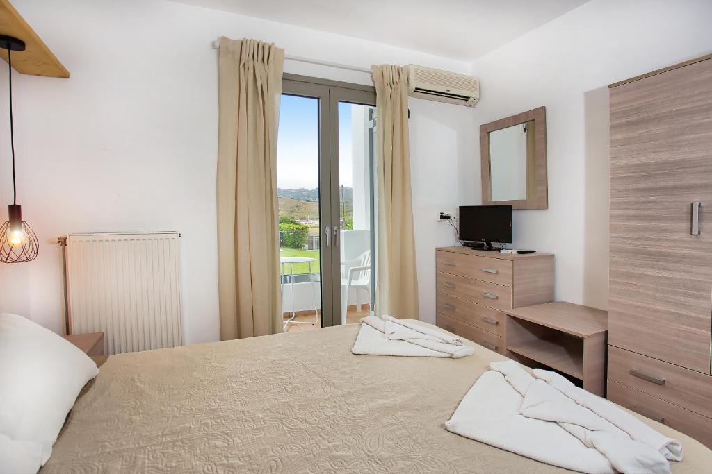 Posteľ alebo postele v izbe v ubytovaní Achilli Apartments