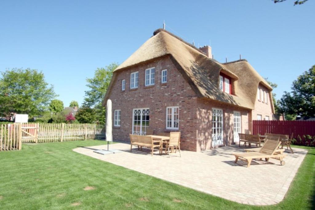 a large brick house with a thatched roof at Ohl Doerp 55b_ Whg_ 2 in Wrixum