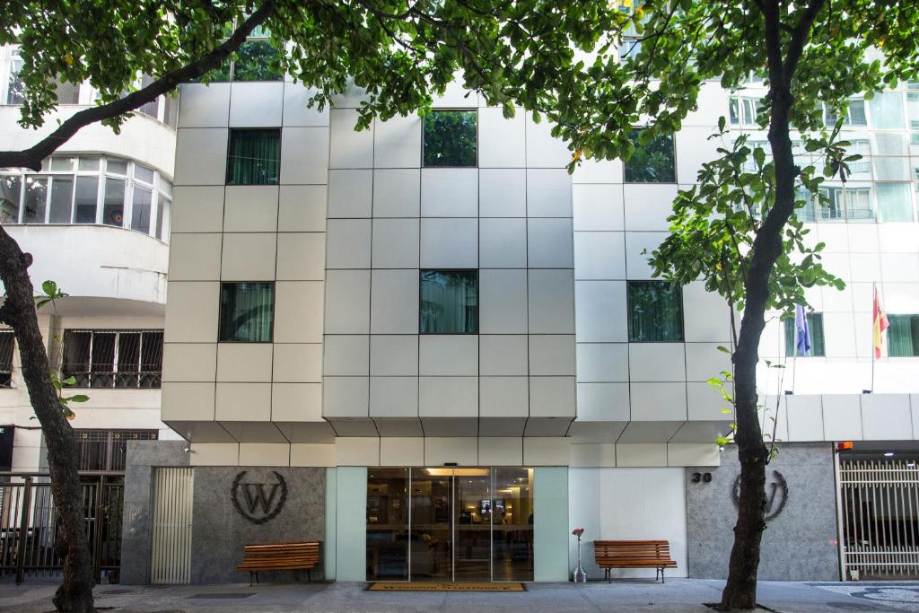 a white building with trees in front of it at Windsor Martinique Copacabana in Rio de Janeiro