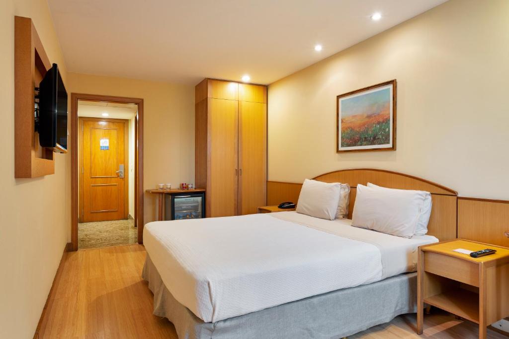 a bedroom with a large white bed in a room at Windsor Martinique Copacabana in Rio de Janeiro