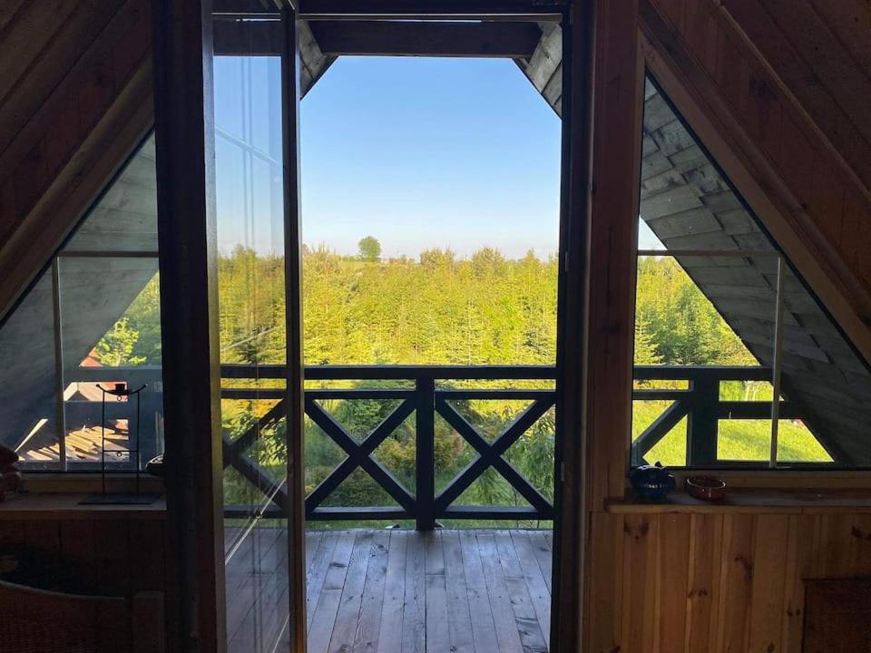 an open door to a room with a view of a field at Domek Stojkowo in Stojkowo