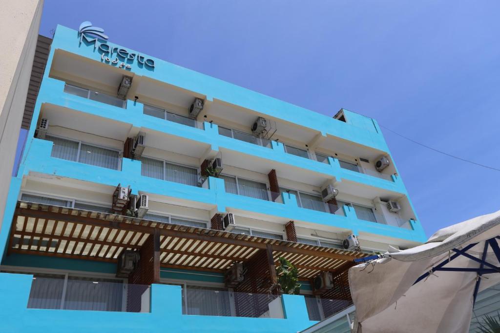 a blue hotel building with a balcony at Hotel Maresta Lodge - Hotel Asociado Casa Andina in Chimbote