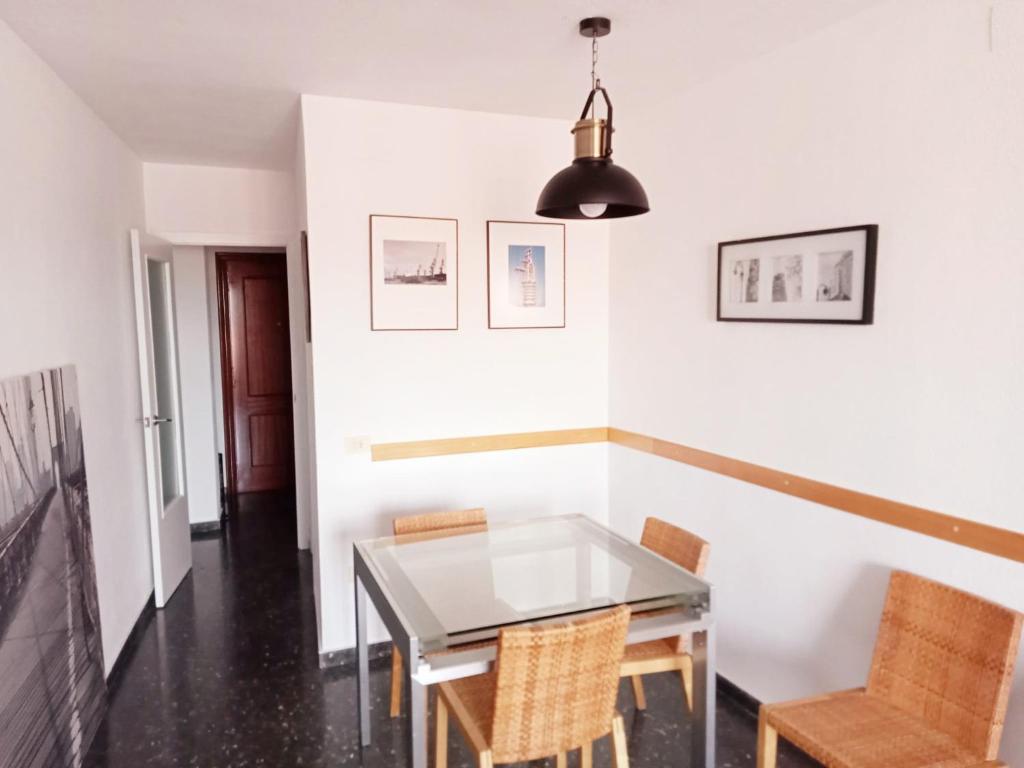 uma sala de jantar com uma mesa de vidro e cadeiras em Precioso aptmento en Gilet a pies de la Calderona em Gilet