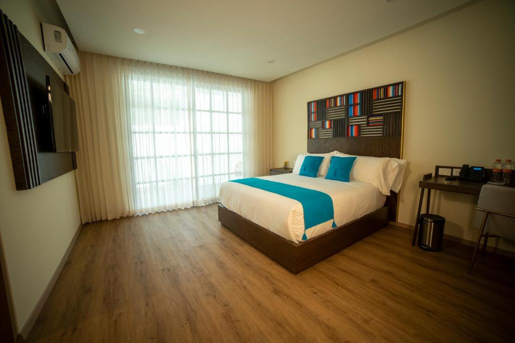 Postel nebo postele na pokoji v ubytování Hotel Dex Tlaquepaque