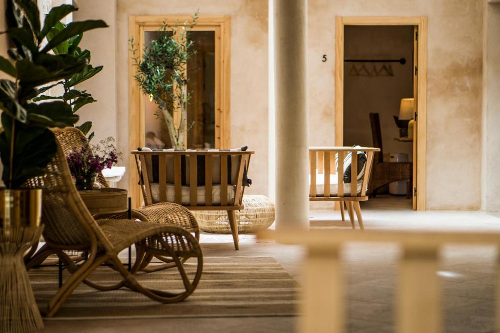 a room with chairs and a table with plants at VICTORIA - Adults Only by Ático73 in Medina Sidonia