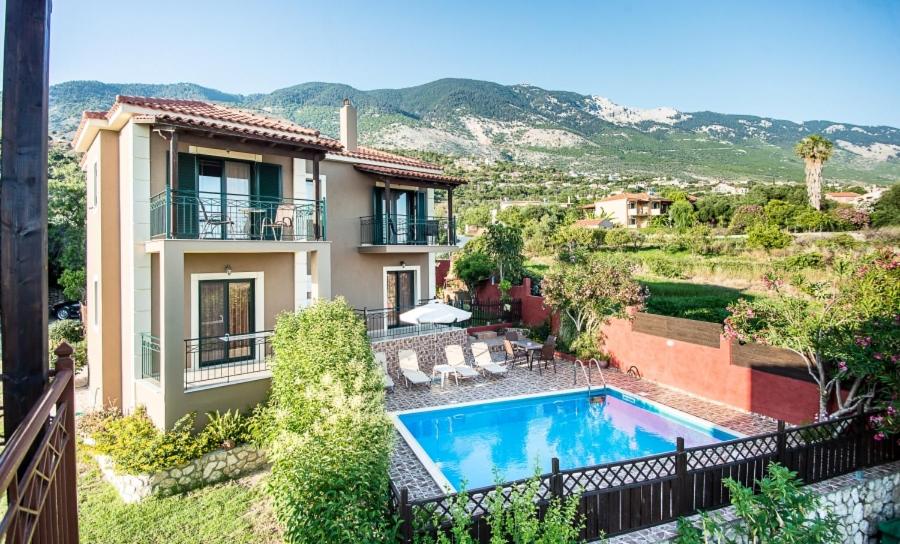 a villa with a swimming pool and a house at Villa Nefeli in Trapezaki