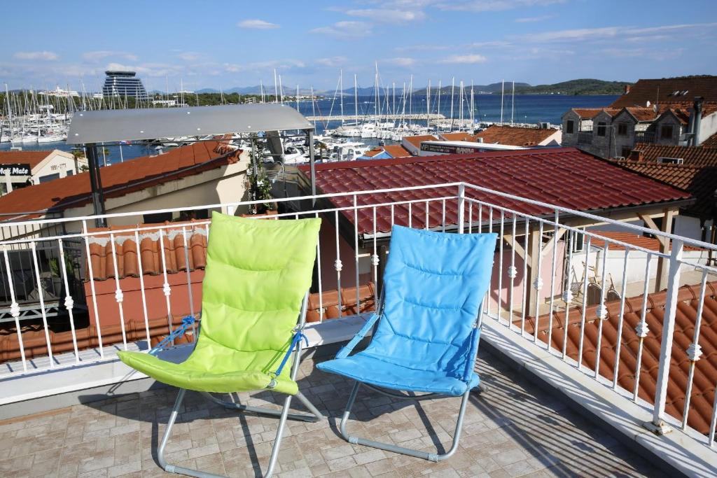 two chairs sitting on top of a balcony at Holiday Home Yan with bay view in Vodice