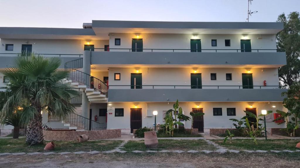 a large white building with stairs in front of it at Garden City Image in Tigaki