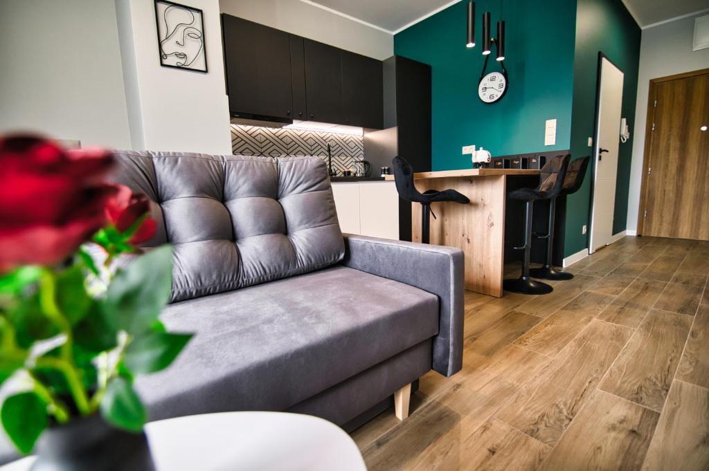 a living room with a couch and a kitchen at Apartament Emi Zator by Housine in Zator
