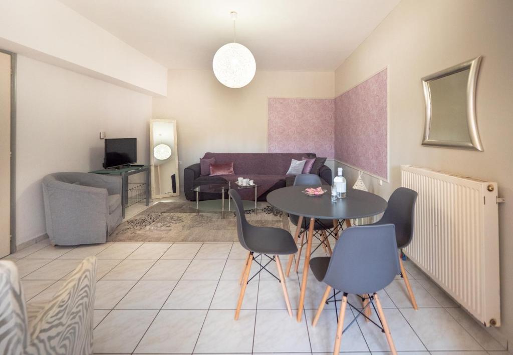 a living room with a table and a couch at Ιάνθη Ianthi apartment in Heraklio Town