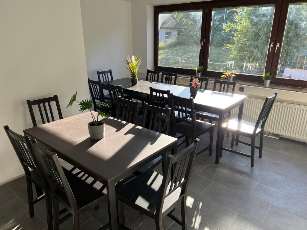 uma sala de jantar com mesas e cadeiras e uma janela em Olymp Wettenberg - Monteurzimmer em Launsbach