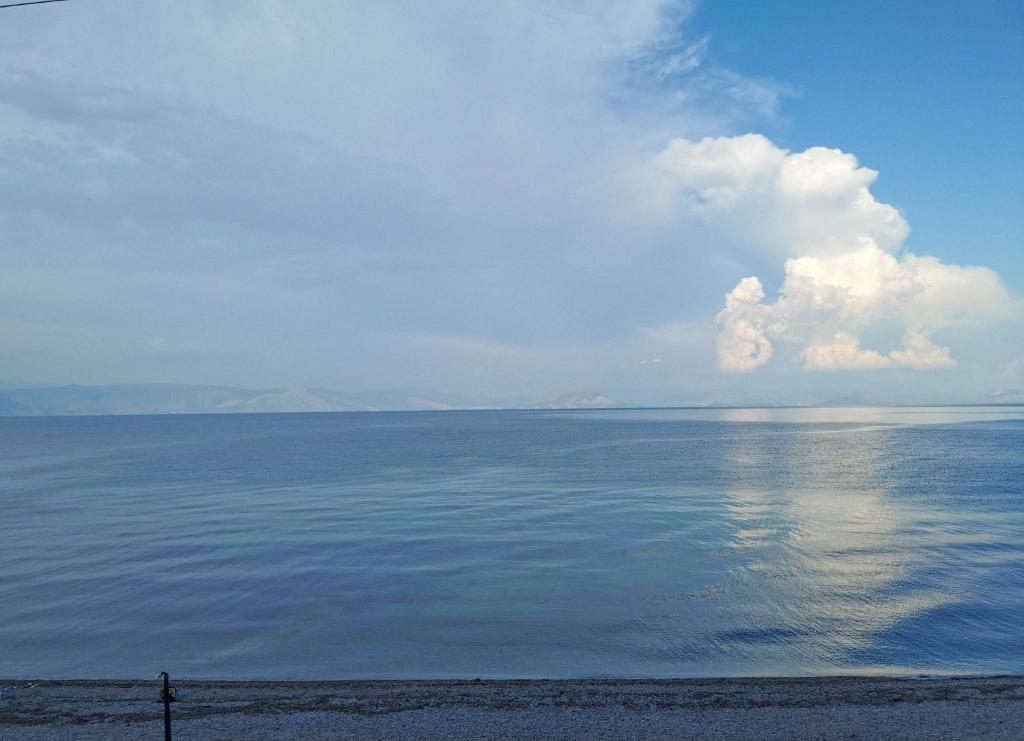 a view of the ocean with a cloud in the sky at MARINA in Perama
