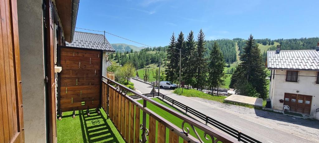 a balcony of a house with a view of a street at Hotel l'Escapade in Beuil