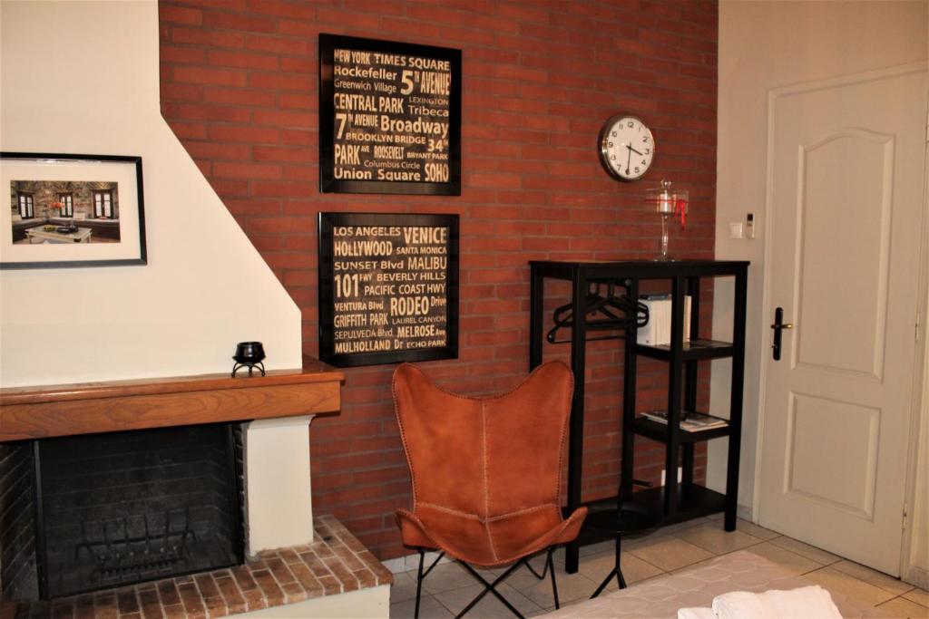 a living room with a brick wall with a fireplace at SpitakiMou #1 - Design Apartment in Volos