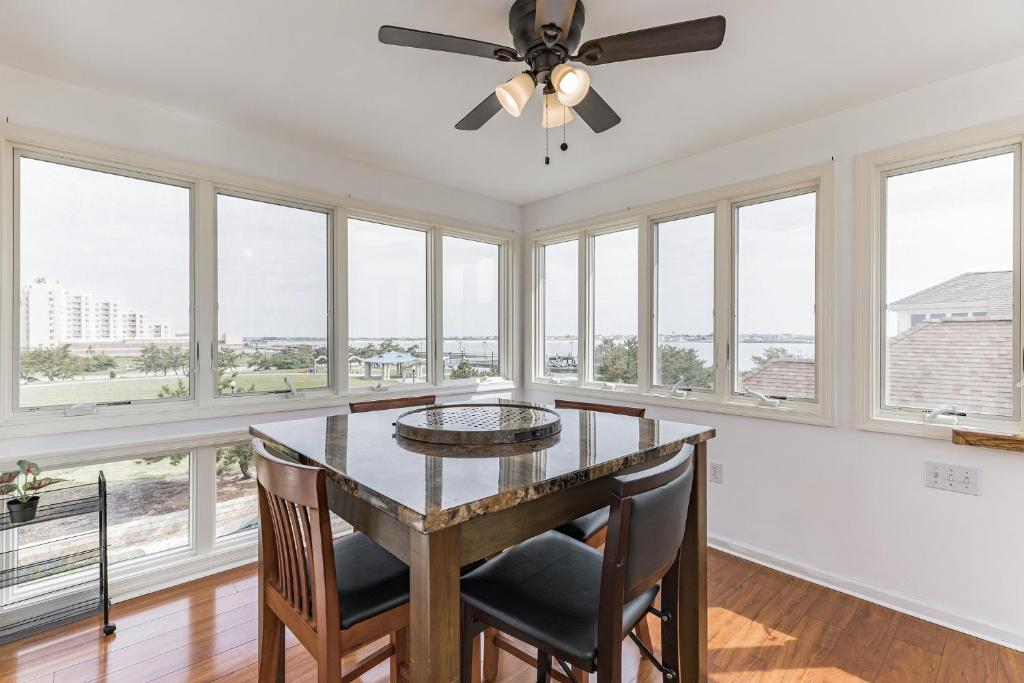 a dining room with a table and chairs and windows at Atlantic City-Waterfront Park-Amazing 360 views in Atlantic City