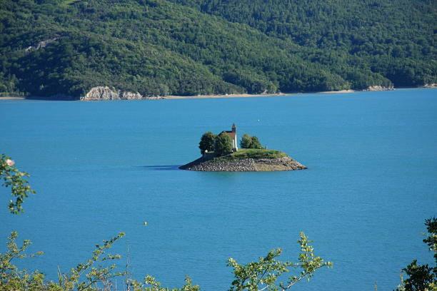 a small island in the middle of a large body of water at Mobile home avec parking in Chorges