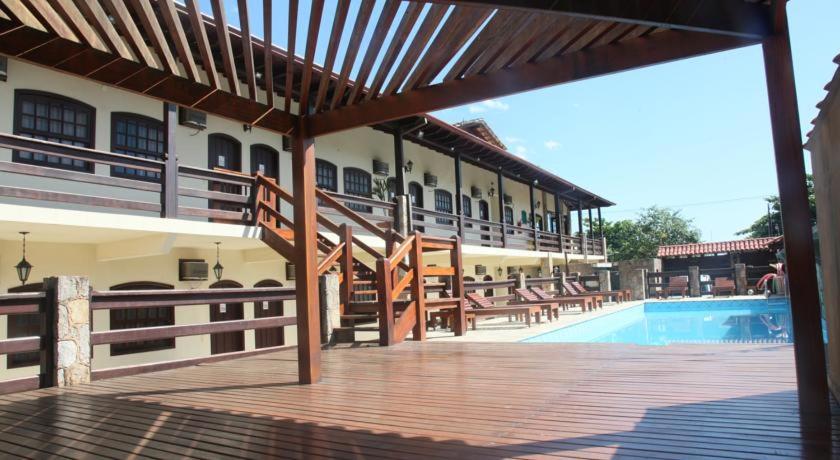 a patio of a hotel with a swimming pool at Pousada Estacao do Sol de Paraty in Paraty