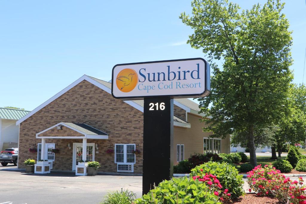 a sign for a car resort in front of a building at Sunbird Cape Cod Resort in West Yarmouth