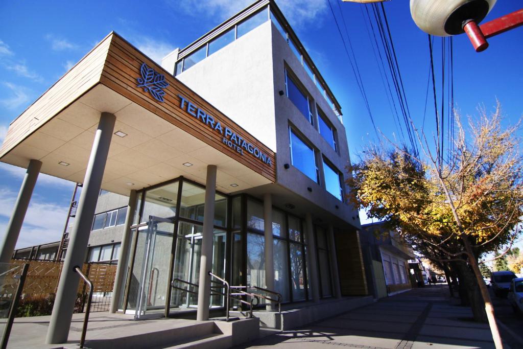 a building with a sign on the front of it at Hotel Terra Patagonia in Malargüe