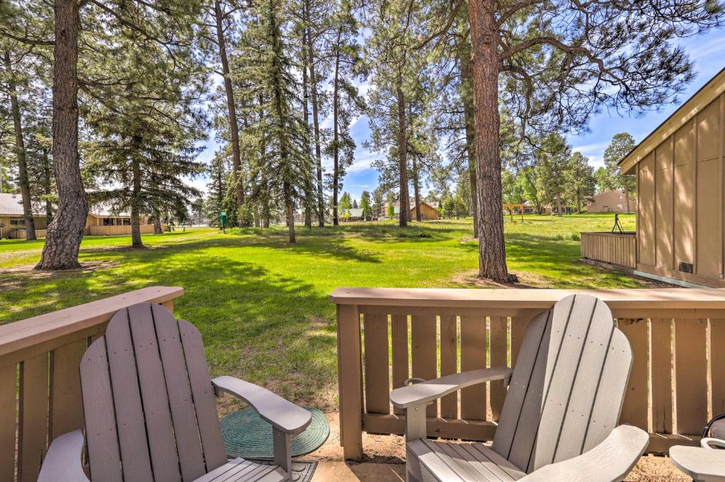 un portico con due sedie, un tavolo e alberi di Cozy Pagosa Springs Townhome with Patio! a Pagosa Springs