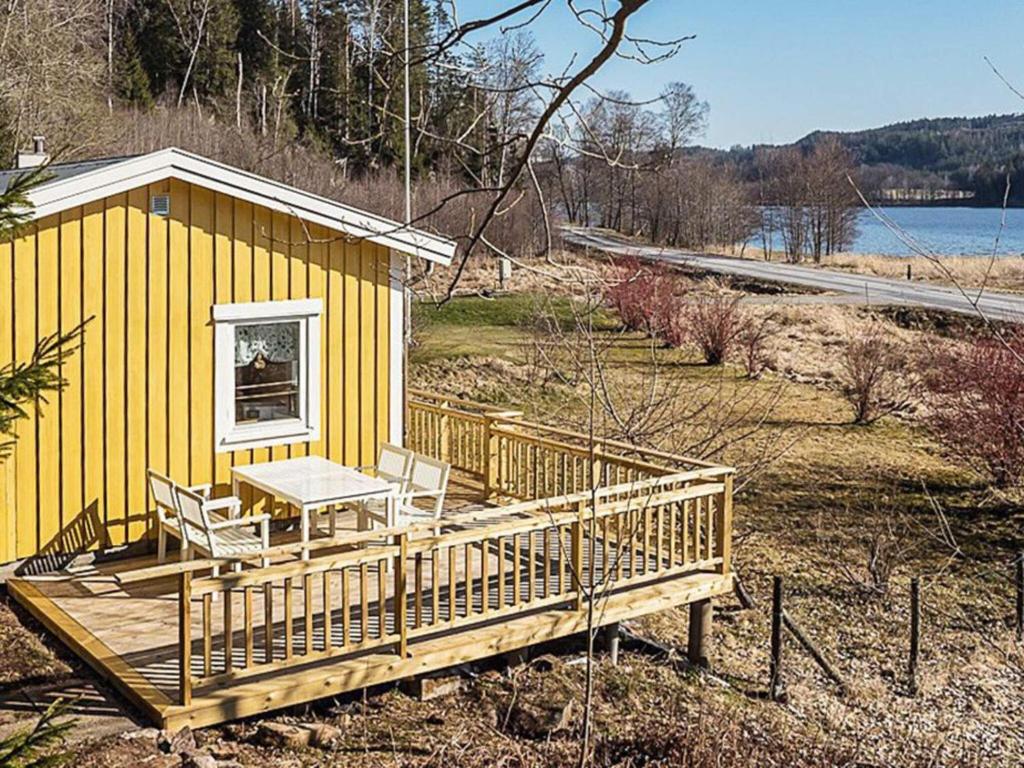 a yellow house with a picnic table on a deck at 4 person holiday home in HÄLLEVADSHOLM-By Traum in Hällevadsholm