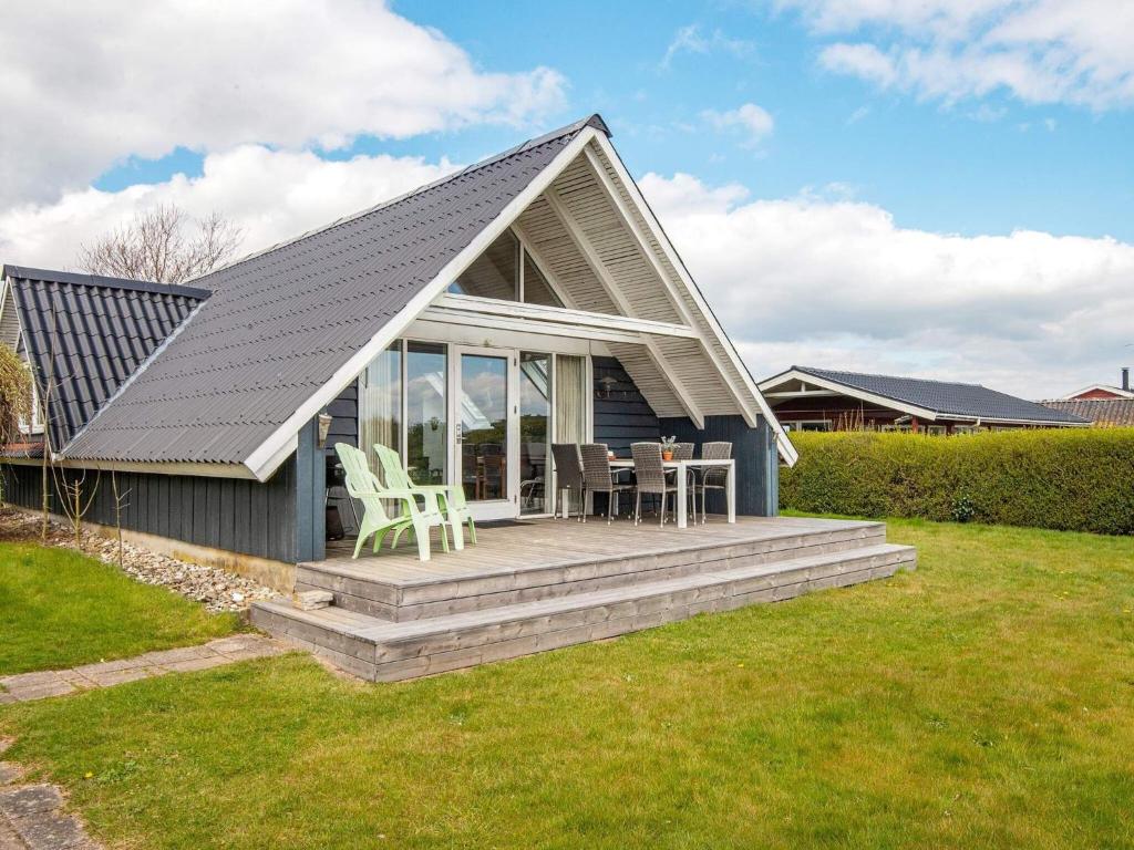 a small house with a porch and a patio at Two-Bedroom Holiday home in Hejls 10 in Hejls