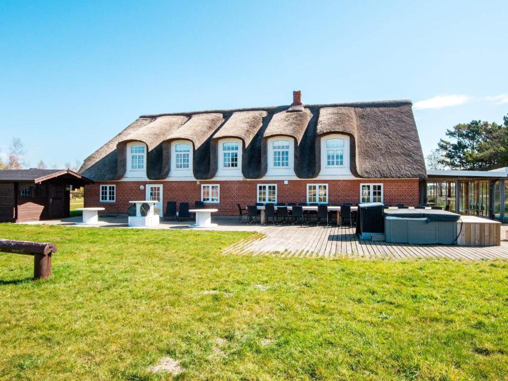 a large brick building with a thatched roof at 25 person holiday home in Rømø-By Traum in Mølby