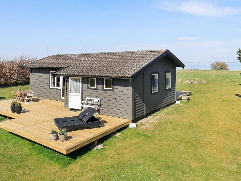 a small cabin with a deck and a house at Holiday home Ærøskøbing XII in Ærøskøbing