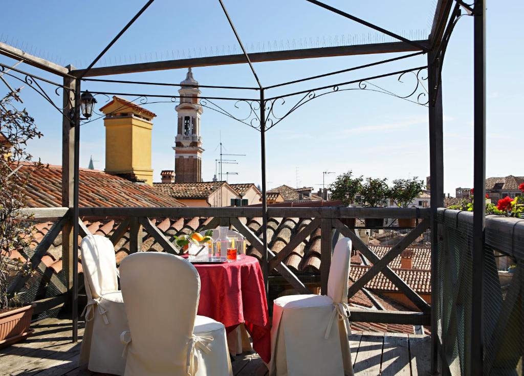 a table and chairs on a balcony with a view at Hotel Ca&#39; D&#39;Oro in Venice