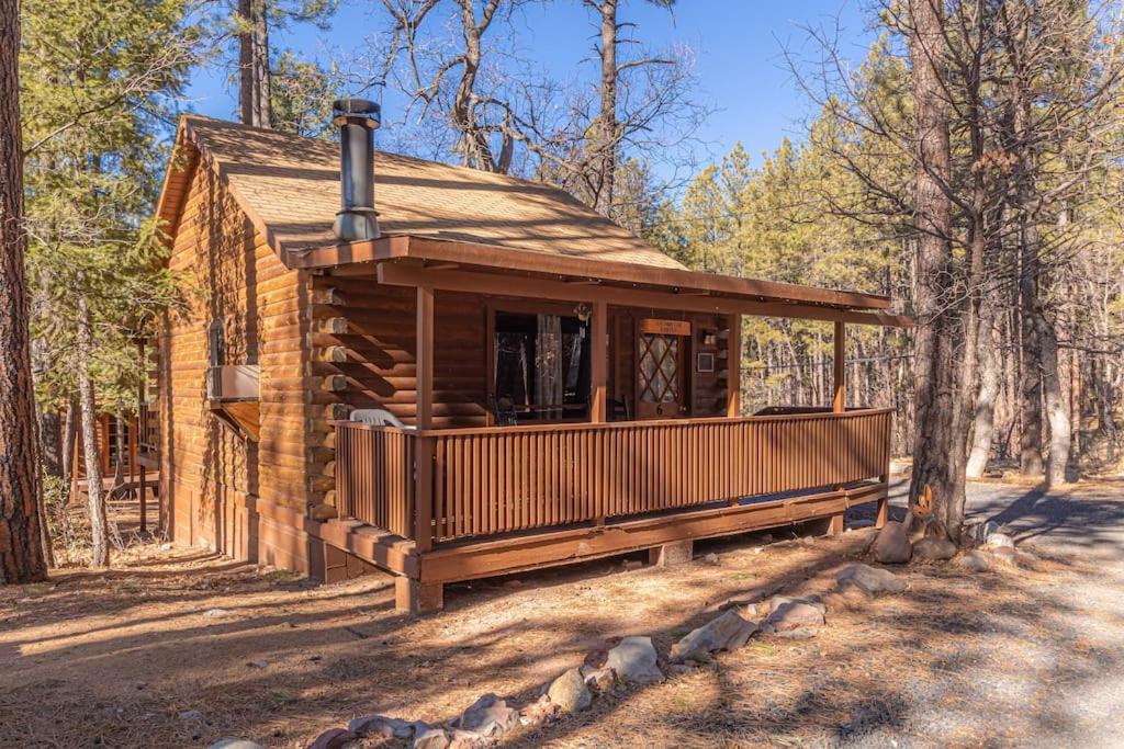 a log cabin in the middle of the woods at Forest Cabin 6 Enchanted Forest in Payson