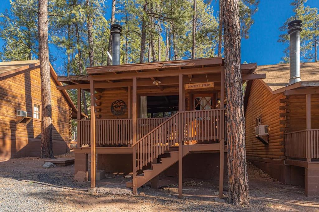 a log cabin with a porch and a tree at Forest Cabin 4 Cowboys Dream in Payson