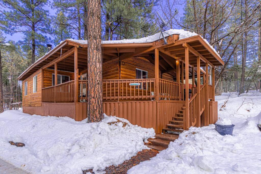 a wooden cabin in the woods in the snow at Forest Cabin 7 Seventh Heaven in Payson