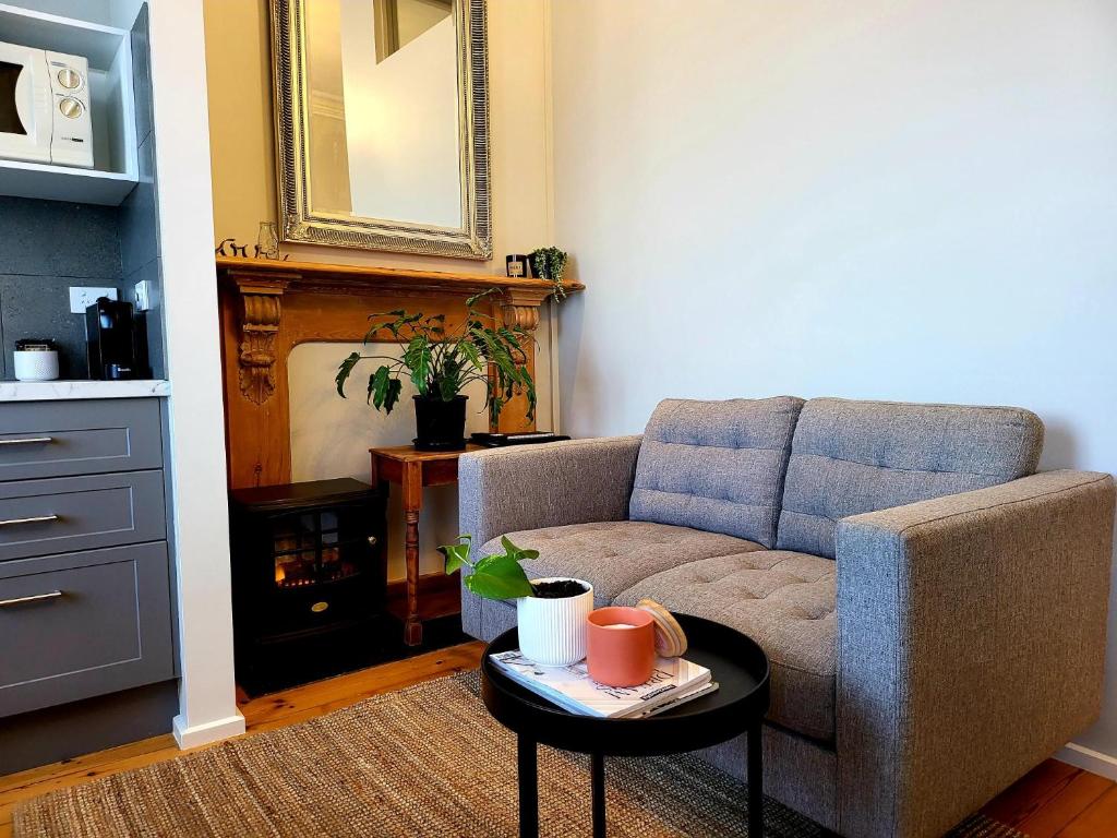 a living room with a couch and a coffee table at Annesley House in Portland
