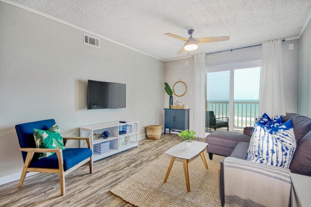 a living room with a couch and a tv at Windy Village C-6 in Myrtle Beach