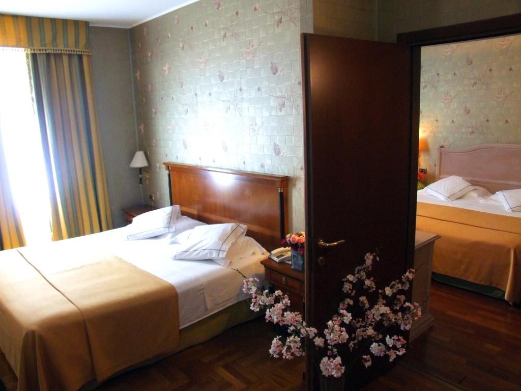 Postel nebo postele na pokoji v ubytování Hotel Palazzo Lovera