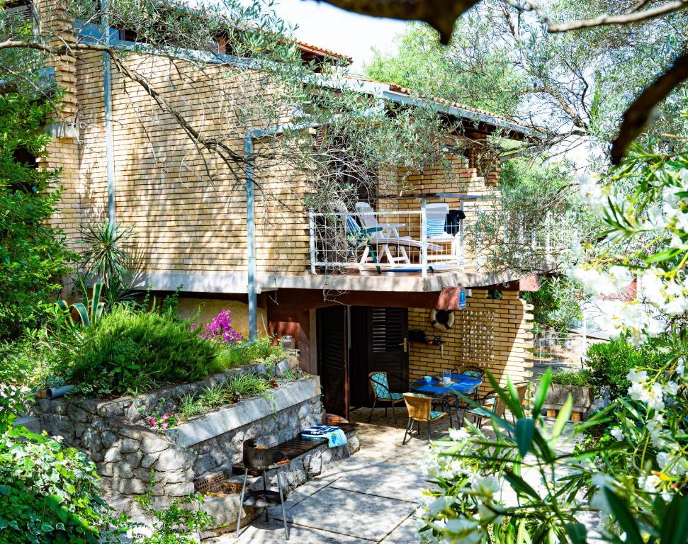a brick house with a balcony and a patio at Hidden Gem of Krasici in Radovići