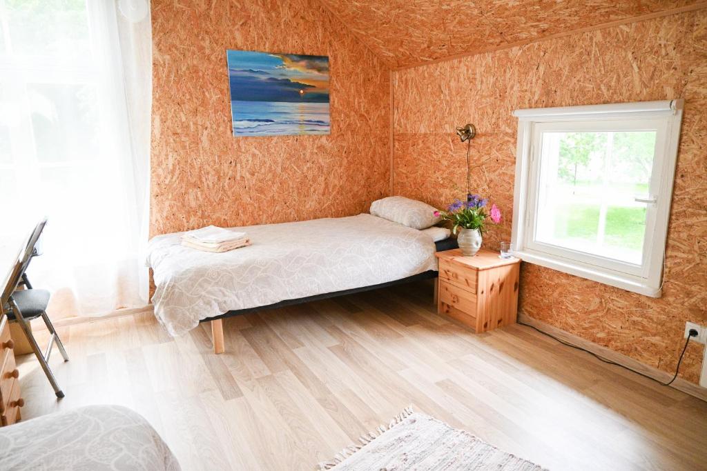 a bedroom with two beds and a window at Haapsalu Kunstikooli hostel in Haapsalu
