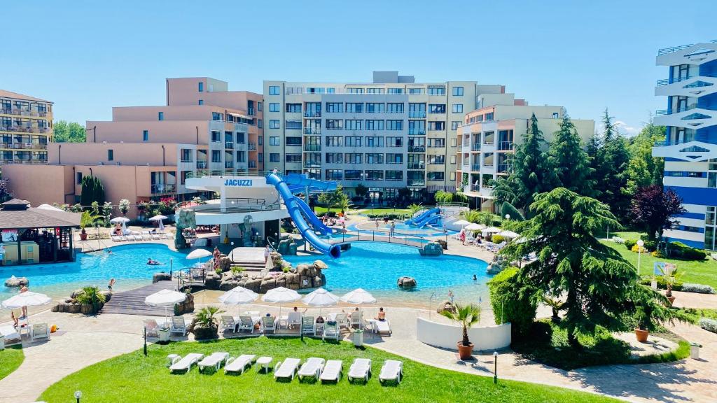 a large pool with a slide in a resort at Bratanov Trakia Apartments in Sunny Beach