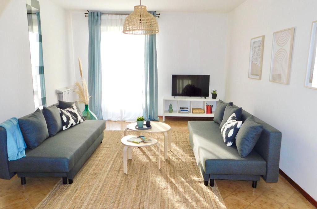 a living room with two couches and a table at Casa Azzurra in Marzocca di Senigallia