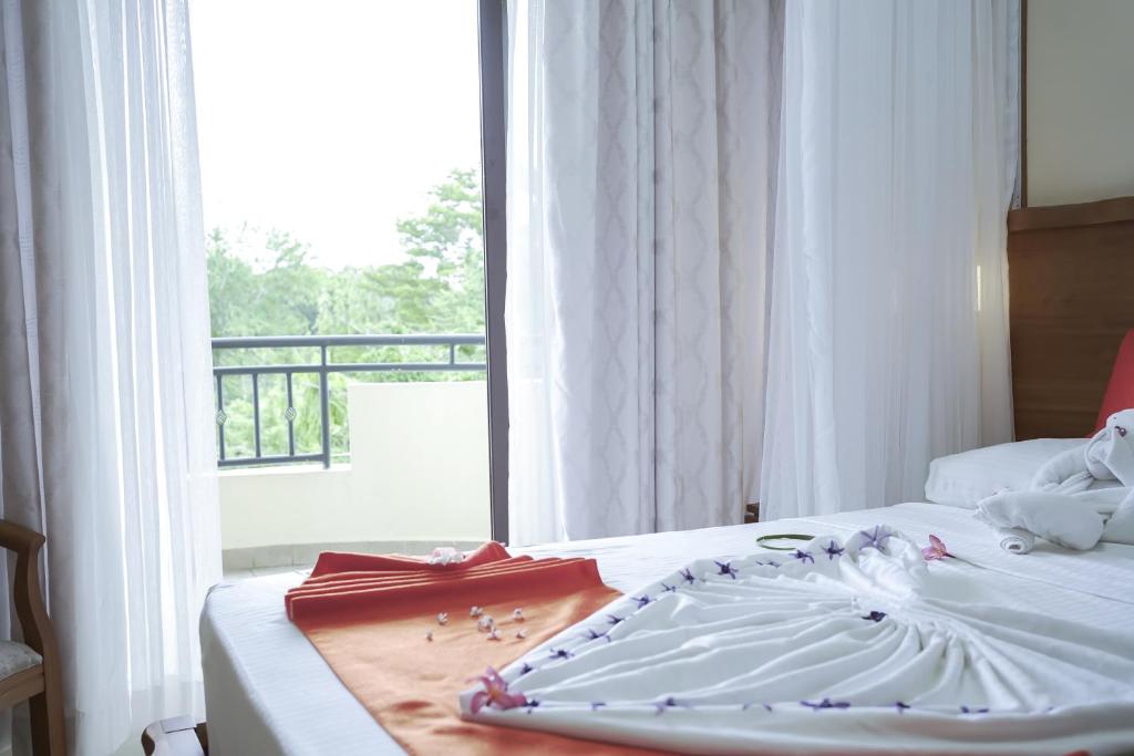 Postel nebo postele na pokoji v ubytování Hotel Comster Mtwapa