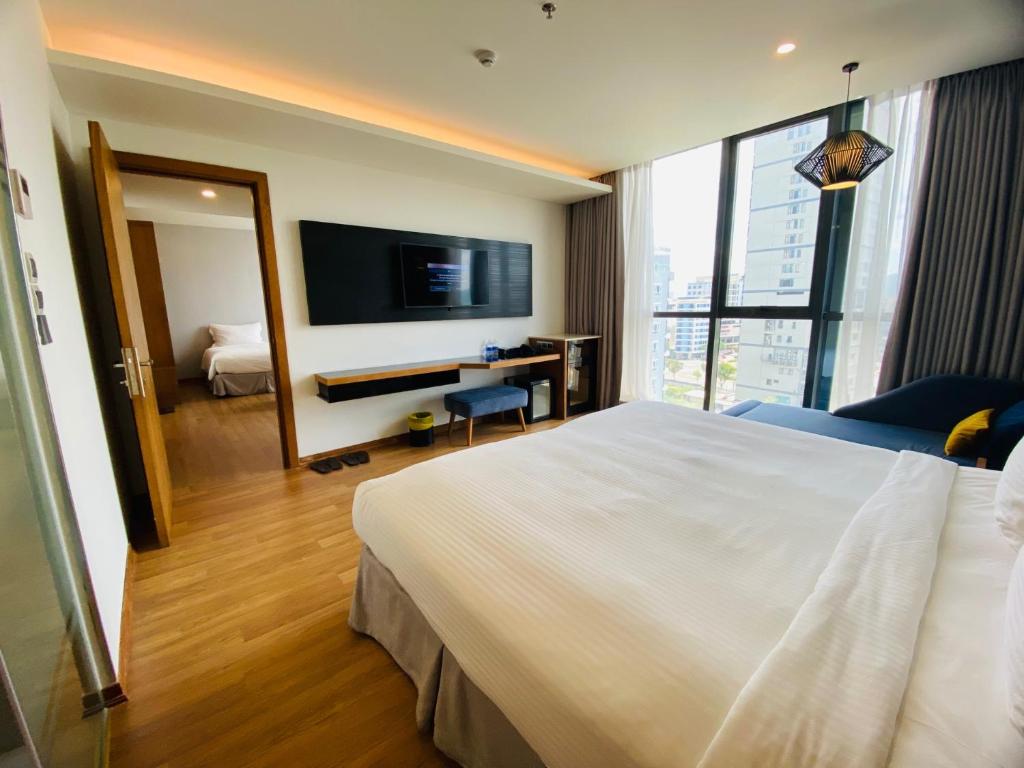 TV a/nebo společenská místnost v ubytování NAM Hotel & Residences