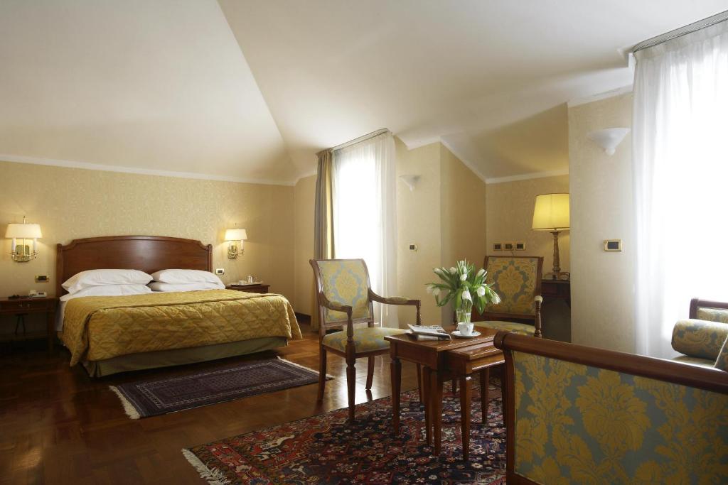 Postel nebo postele na pokoji v ubytování Hotel Palazzo Lovera