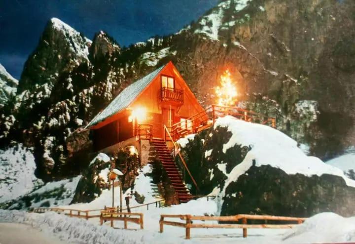 a ski lodge with snow on a mountain at Il nido (Cica) in Sottoguda