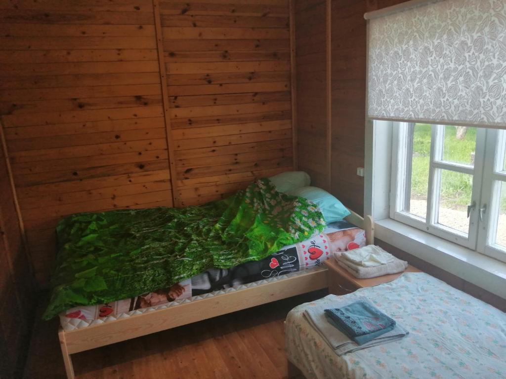 um pequeno quarto com uma cama e uma janela em Niedres 