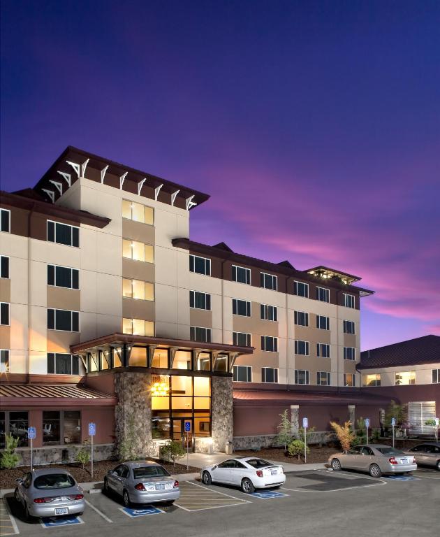 a rendering of a hotel with cars parked in a parking lot at Seven Feathers Casino Resort in Canyonville