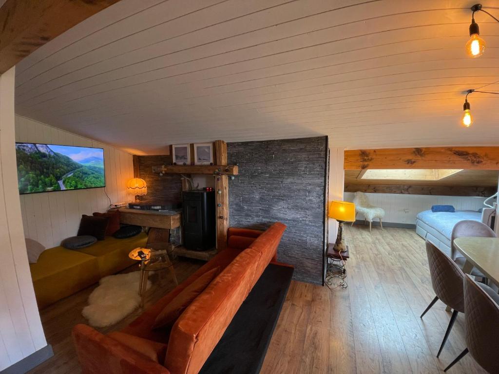 a living room with a couch and a bed at Appartement en plein centre du village (6-8 personnes) in Les Contamines-Montjoie
