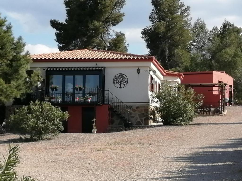 a house with a large window and a driveway at Los Valientes Gitanos in Jarafuel