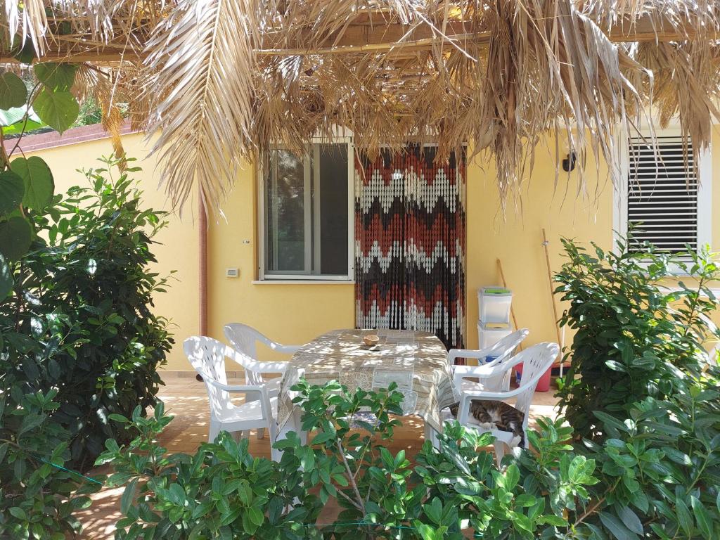 a patio with a table and chairs in a yard at Casa tra mare e oliveti in Caprioli