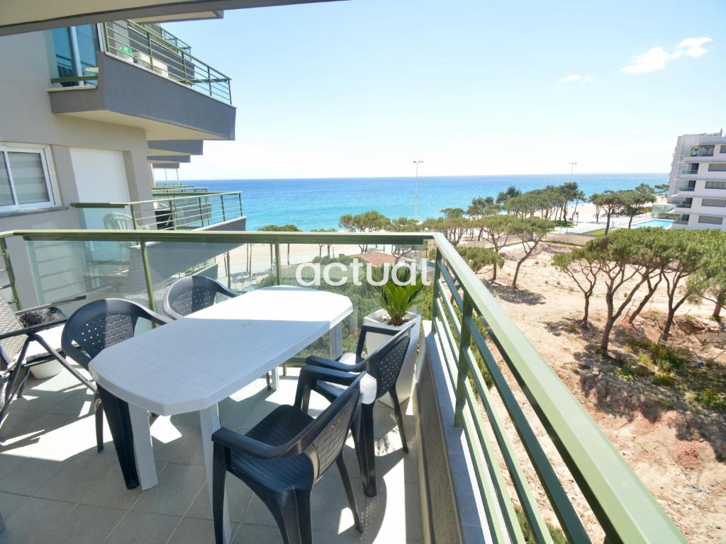 a balcony with a table and chairs and the ocean at Fanals 4M in Platja d'Aro